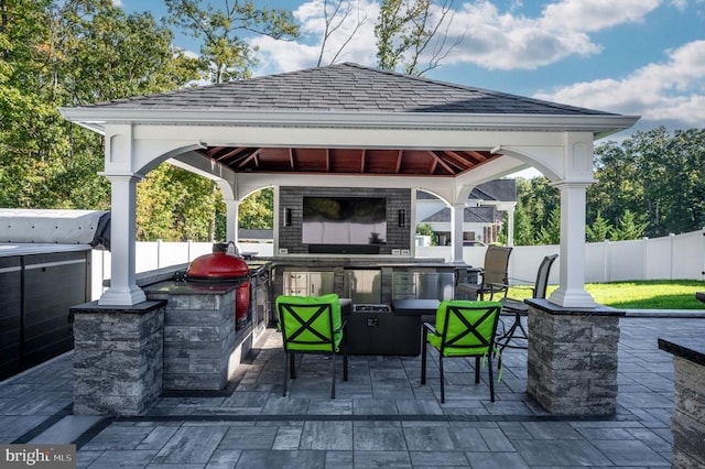 view of patio / terrace with a gazebo, exterior bar, area for grilling, and fence