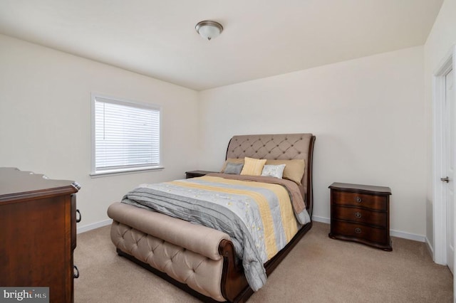 carpeted bedroom featuring baseboards