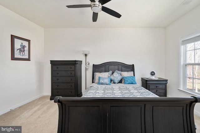 bedroom featuring visible vents, light colored carpet, baseboards, and ceiling fan