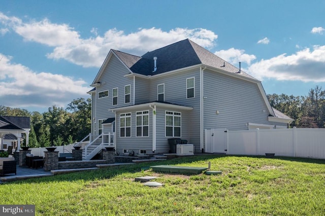 back of property with a patio area, a yard, and fence