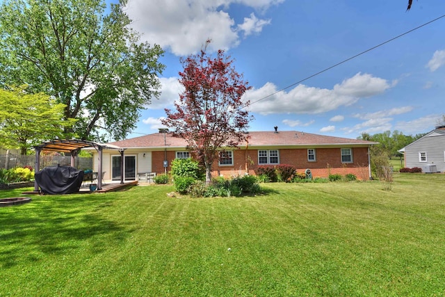 back of property featuring a pergola, brick siding, a patio area, a lawn, and central air condition unit