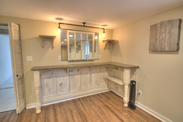 interior space featuring baseboards and wood finished floors