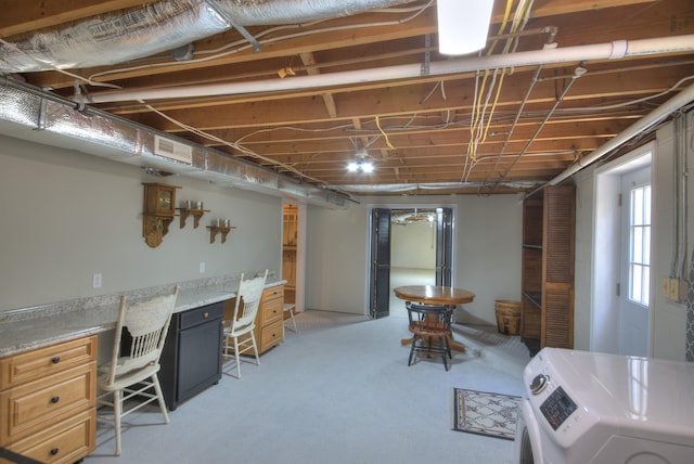 below grade area featuring visible vents and washer and clothes dryer
