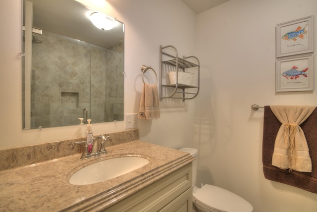bathroom featuring vanity, toilet, and a shower stall