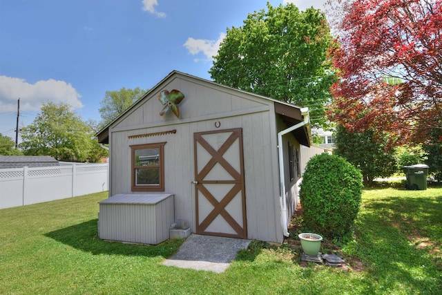view of shed featuring fence