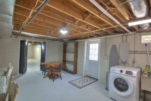 washroom featuring washer / dryer, laundry area, and a sink