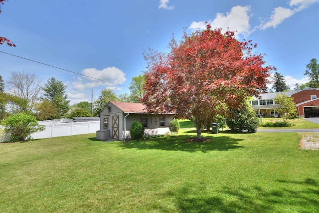 view of yard with fence and an outdoor structure