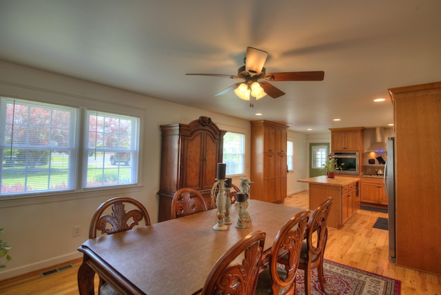 dining area with light wood-style flooring, a ceiling fan, baseboards, recessed lighting, and visible vents
