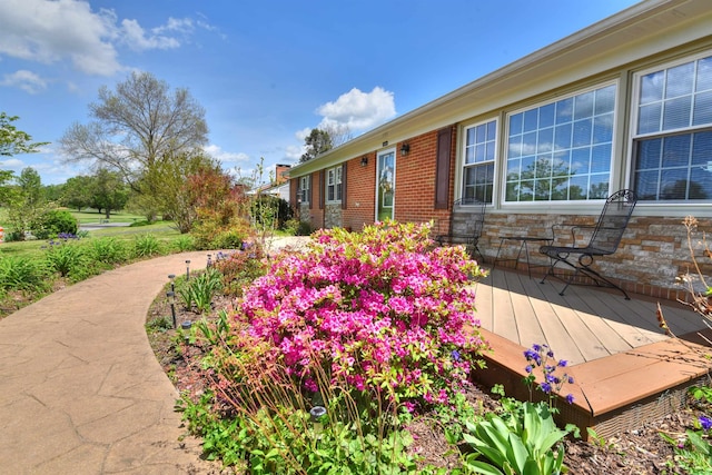 exterior space with brick siding and stone siding