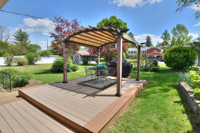 deck featuring fence, a pergola, outdoor dining space, area for grilling, and a yard