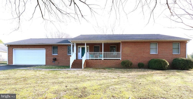 ranch-style house featuring brick siding, an attached garage, a porch, a front yard, and driveway