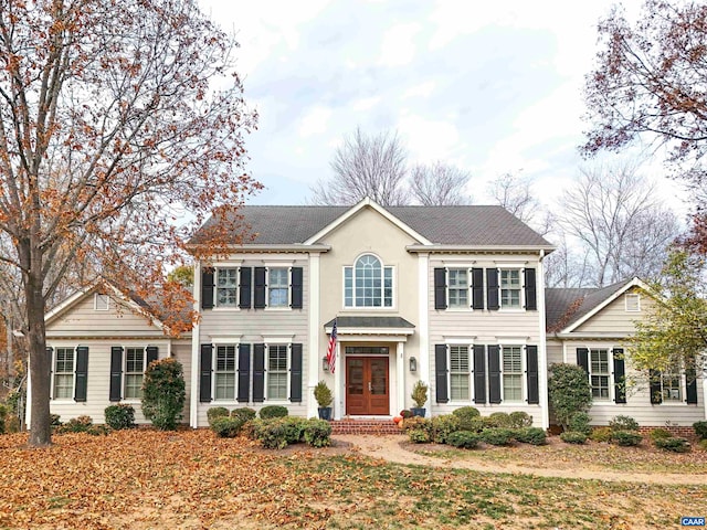 colonial-style house with french doors