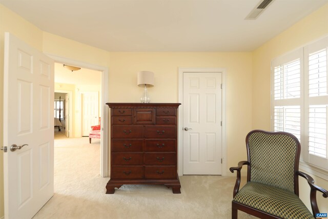 living area featuring light carpet