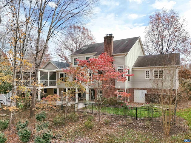 back of property with a sunroom