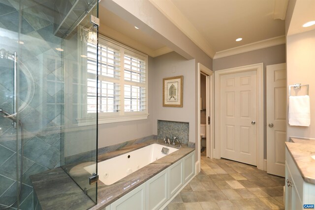 full bathroom featuring ornamental molding, shower with separate bathtub, vanity, and toilet