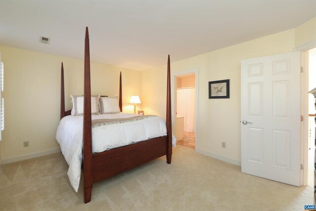 carpeted bedroom featuring connected bathroom