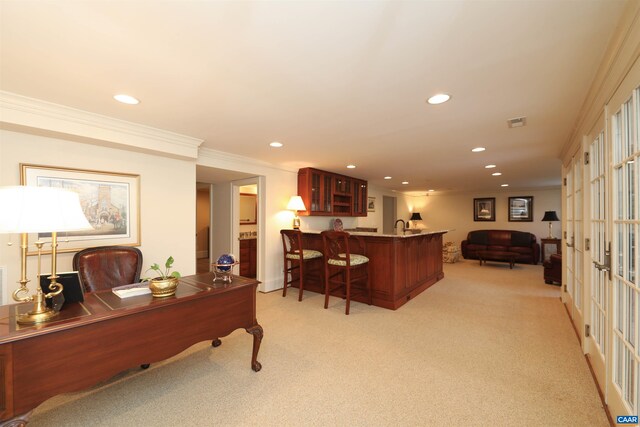 office space with crown molding, indoor bar, light colored carpet, and french doors