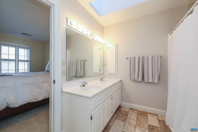 bathroom with vanity and a skylight