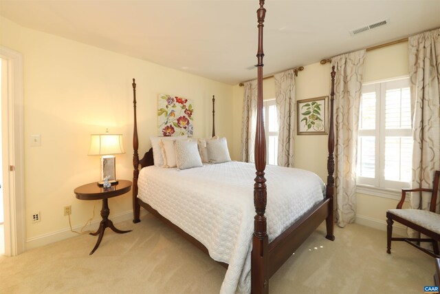 bedroom featuring light colored carpet