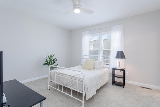 carpeted bedroom with baseboards, visible vents, and ceiling fan