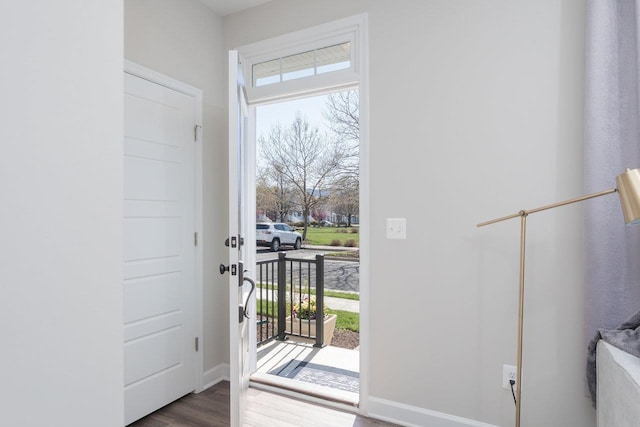 entryway with baseboards, dark wood-style floors, and plenty of natural light