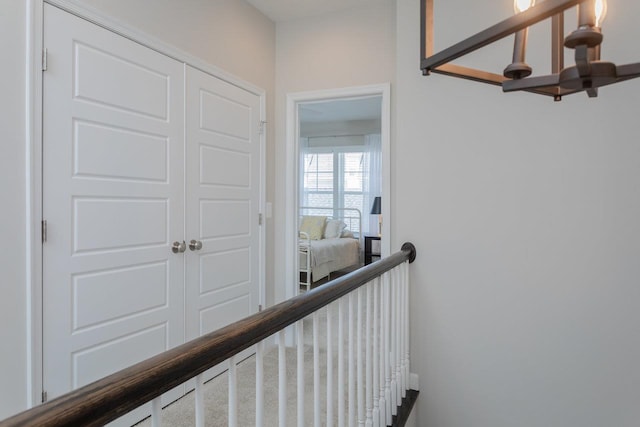 hallway featuring an upstairs landing