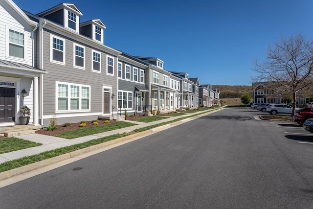 view of road with sidewalks and a residential view