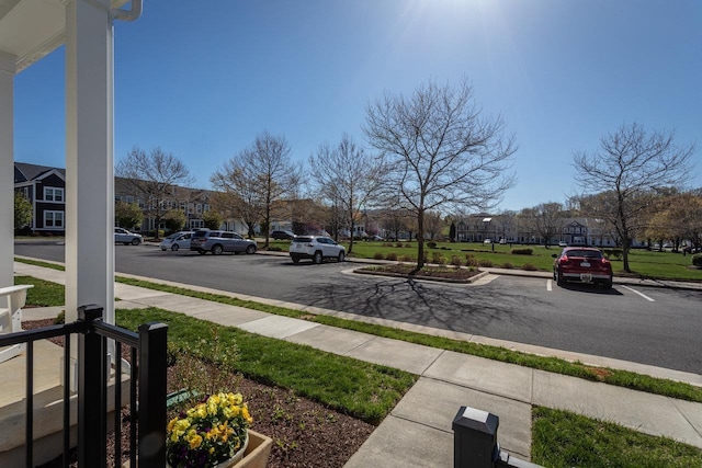 view of road featuring a residential view, sidewalks, and curbs