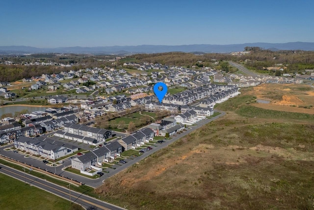 birds eye view of property with a water and mountain view and a residential view