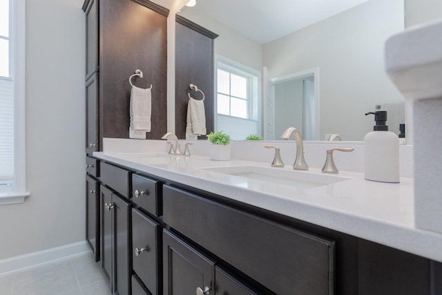 bathroom featuring double vanity, tile patterned flooring, and a sink