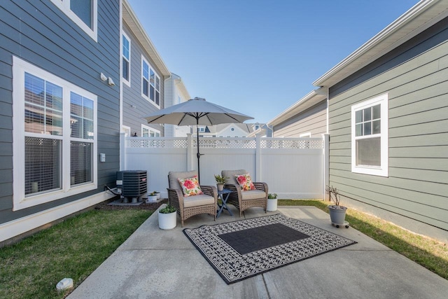 view of patio with fence and cooling unit