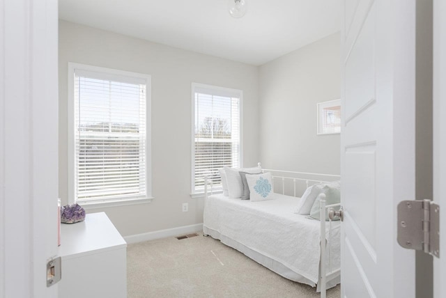 bedroom featuring light colored carpet, baseboards, and visible vents