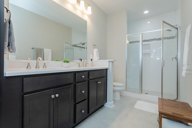 full bathroom featuring double vanity, a stall shower, and a sink