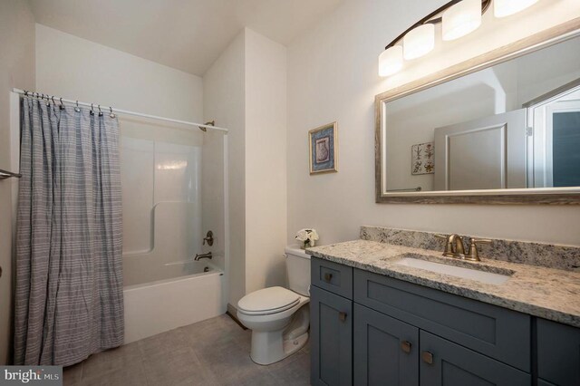 full bath featuring vanity, shower / tub combo with curtain, tile patterned flooring, and toilet