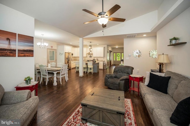 living room featuring visible vents, lofted ceiling, dark wood finished floors, and ceiling fan with notable chandelier