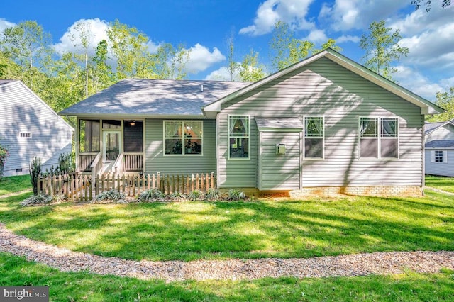 view of front of property featuring a sunroom and a front lawn