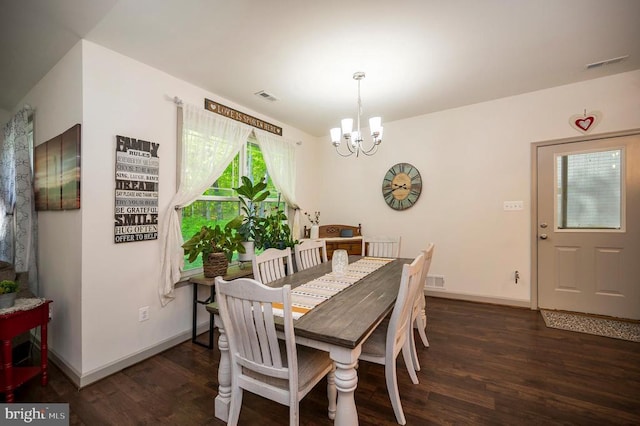 dining area with an inviting chandelier, baseboards, wood finished floors, and visible vents
