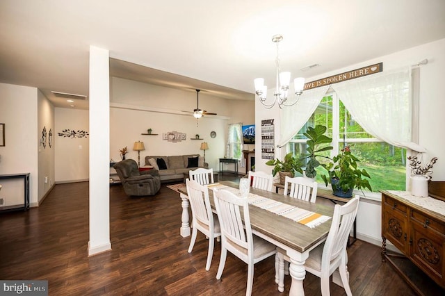 dining area with dark wood-style flooring, visible vents, and ceiling fan with notable chandelier