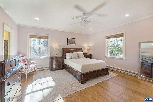 bedroom featuring recessed lighting, a baseboard heating unit, light wood-style floors, and crown molding