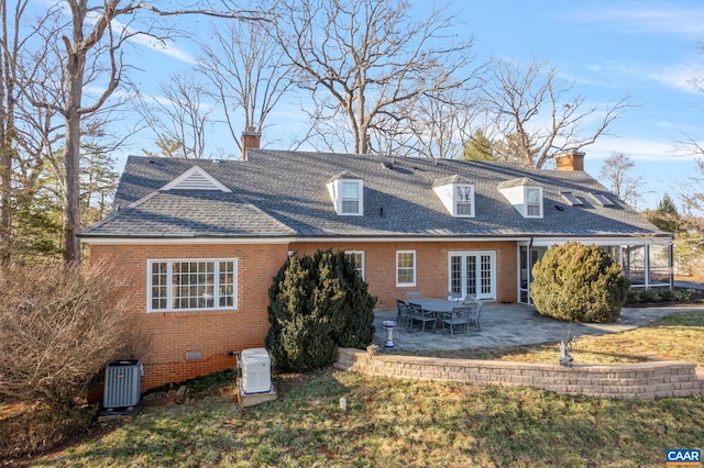 back of house with french doors, crawl space, brick siding, a chimney, and a patio area