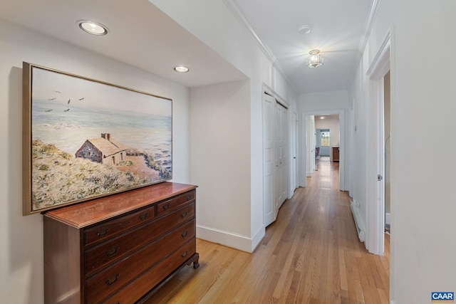 hall featuring recessed lighting, baseboards, light wood-style floors, and crown molding