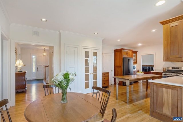 dining room featuring visible vents, recessed lighting, light wood-style floors, french doors, and crown molding