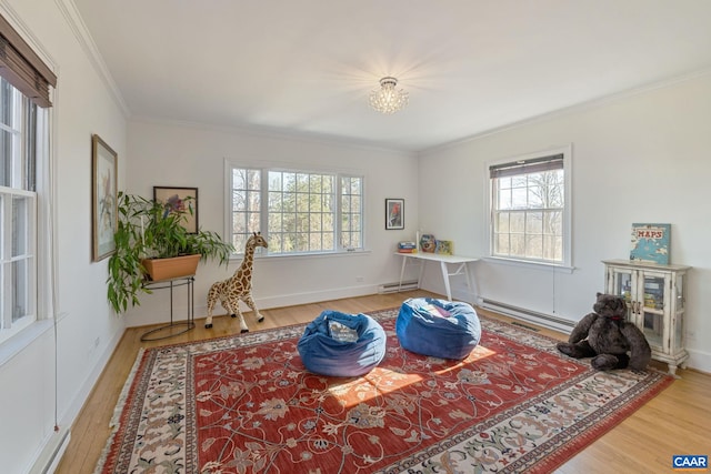 living area featuring a baseboard radiator, wood finished floors, and ornamental molding