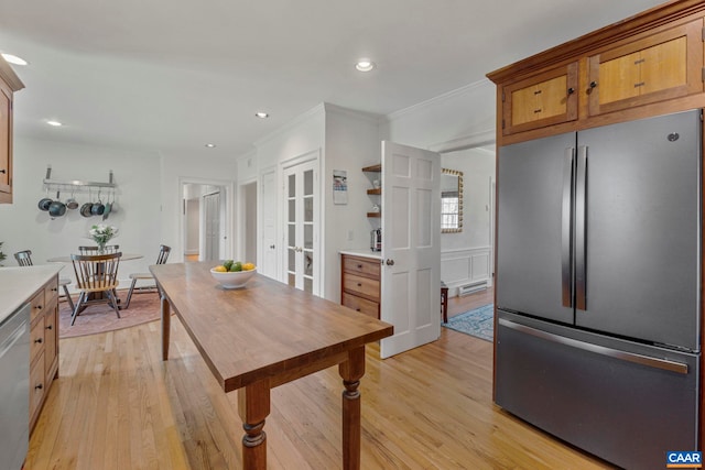 kitchen featuring light countertops, light wood-style flooring, french doors, and stainless steel appliances