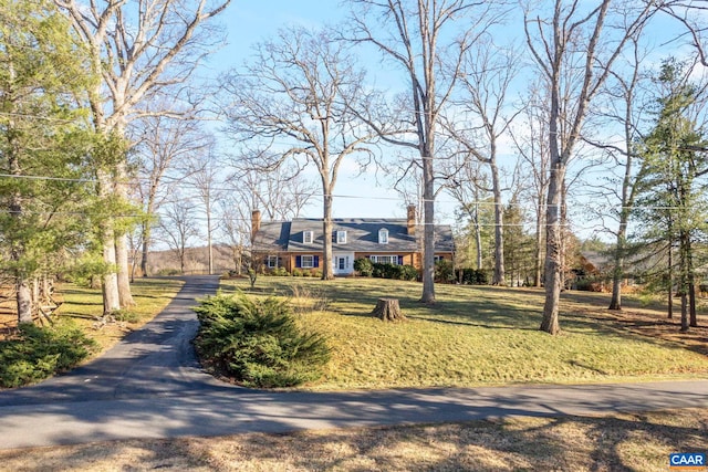 view of front of property featuring a front yard and a chimney