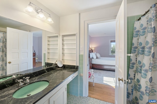 full bath featuring a shower with shower curtain, ensuite bath, and vanity