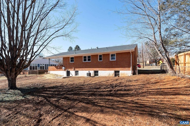 rear view of property featuring central AC