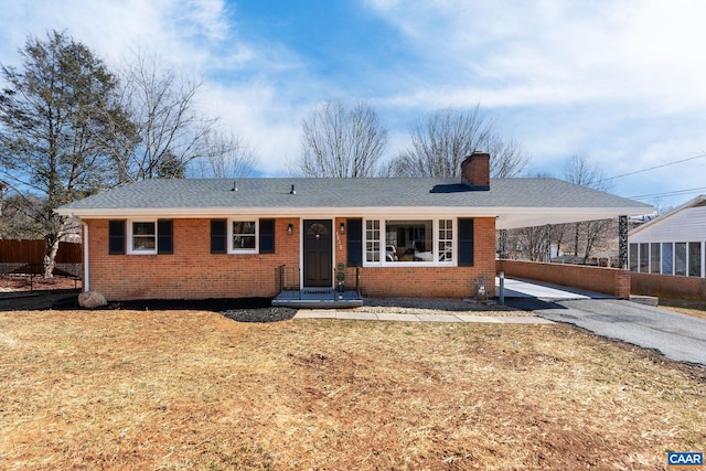 ranch-style home with a front yard and a carport