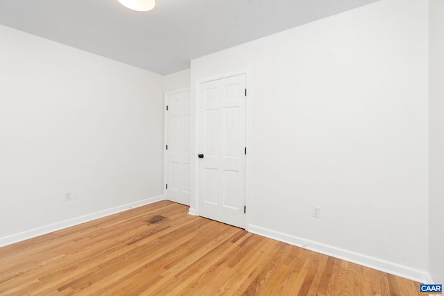 empty room with hardwood / wood-style floors