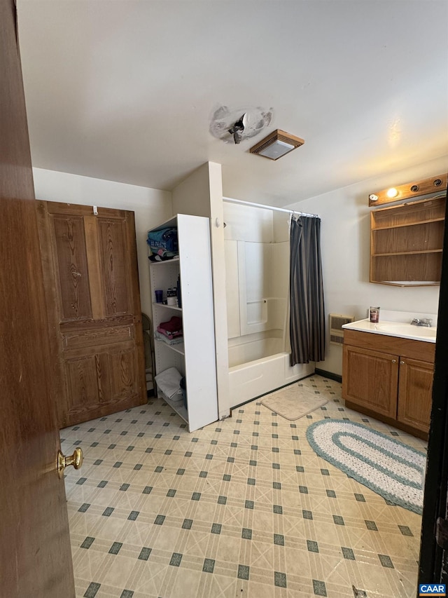 bathroom featuring shower / tub combo and vanity